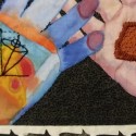 a multicolored left hand and pink right hand have open palms overlapped on a black background with seed stitches. A piece of textured red clay tile sits on the right hand. A black outline of a diagram of a spinning top is on the left hand, a row of repeating words saying turn borders the bottom edge