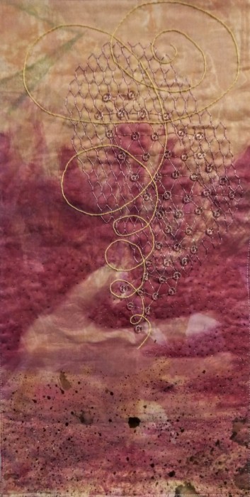 a network of beads spirals up from an open palm embroidered on a background of peach fading into magenta